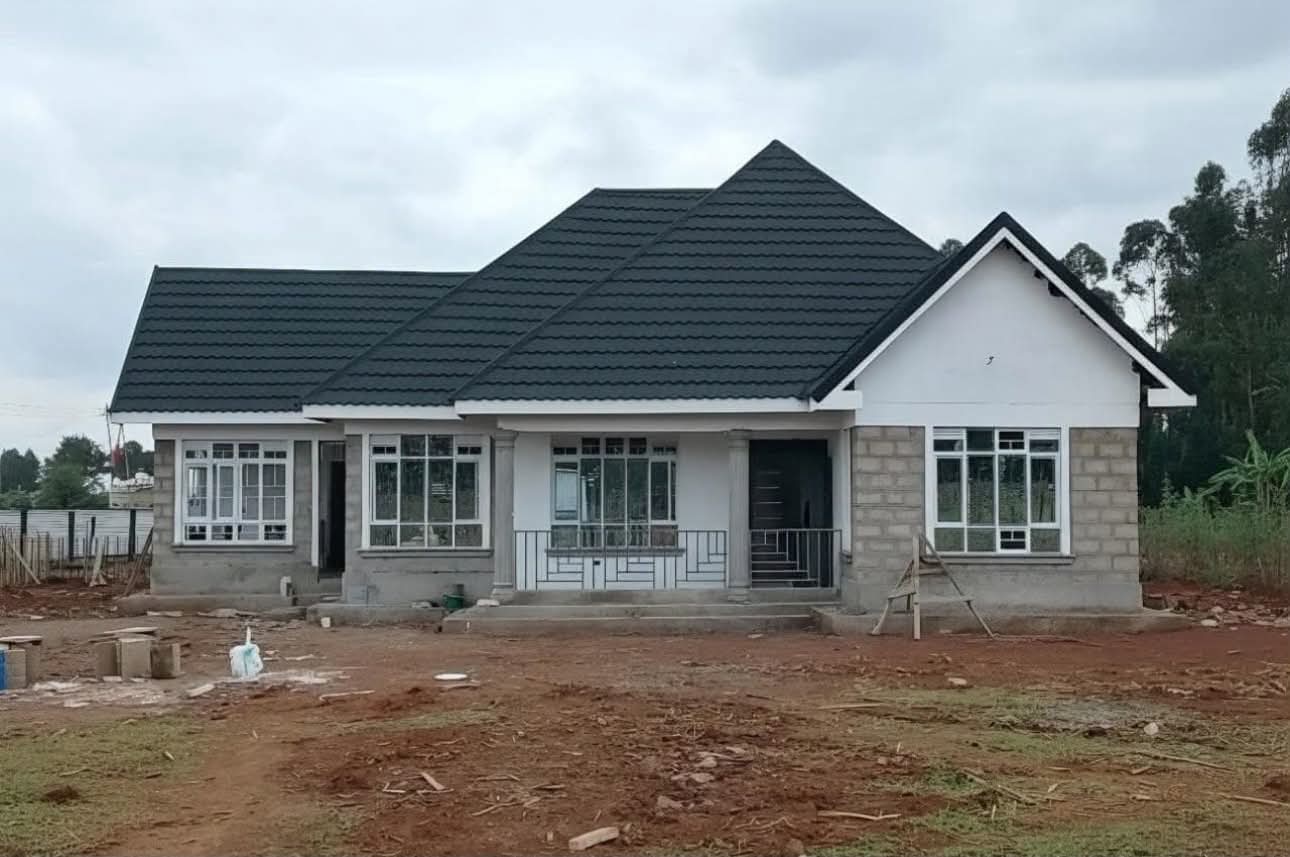 Residential house nearing completion with unfinished external groundworks